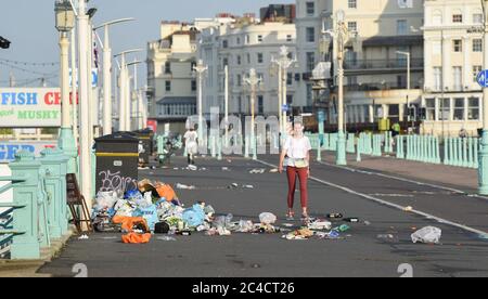 Brighton UK 26th June 2020 - Piles of litter on Brighton beach and seafront this morning which has been left behind by the crowds of visitors yesterday which was the hottest day of the year so far  : Credit Simon Dack / Alamy Live News Stock Photo