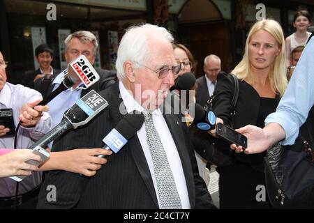 Barrister Greg James QC is surrounded by a media scrum as he leaves the Downing Centre District Court in Sydney. Stock Photo