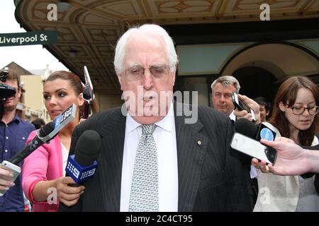 Barrister Greg James QC is surrounded by a media scrum as he leaves the Downing Centre District Court in Sydney. Stock Photo