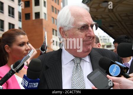 Barrister Greg James QC is surrounded by a media scrum as he leaves the Downing Centre District Court in Sydney. Stock Photo