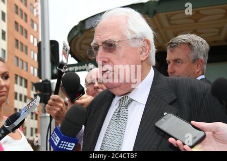 Barrister Greg James QC is surrounded by a media scrum as he leaves the Downing Centre District Court in Sydney. Stock Photo