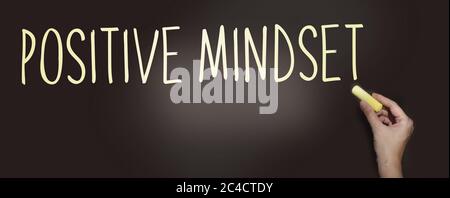 Positive Mindset handwritten with white chalk on a blackboard. Think positively lifestyle state of mind psychological concept Stock Photo