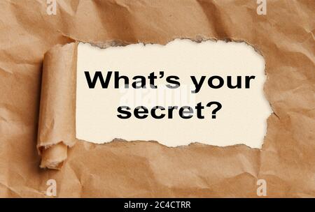 Text Whats your secret appearing behind torn brown paper Stock Photo