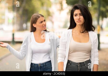 Two Girls Friends Having Quarrel Walking In Park Outdoors Stock Photo