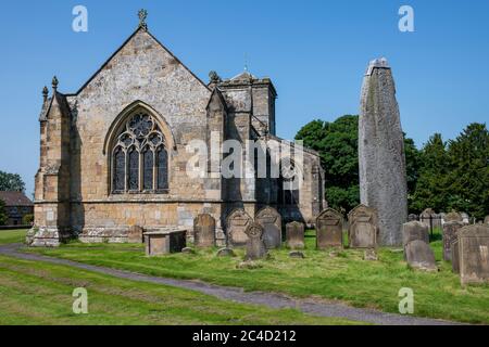 All Saints church beside the tallest (25 feet) Monolithic stone in GB, Rudston, East Yorkshire, UK Stock Photo