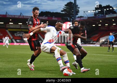 Jordan Ayew of Crystal Palace battles with Jefferson Lerma (R) and Adam Smith (L) of AFC Bournemouth - AFC Bournemouth v Crystal Palace, Premier League, Vitality Stadium, Bournemouth, UK - 20th June 2020  Editorial Use Only - DataCo restrictions apply Stock Photo