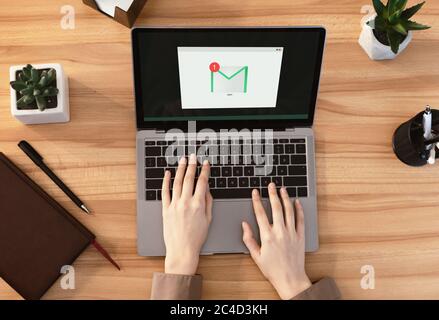 Email Notification. Woman Working On Laptop With Mail Envelope Icon On Screen Stock Photo