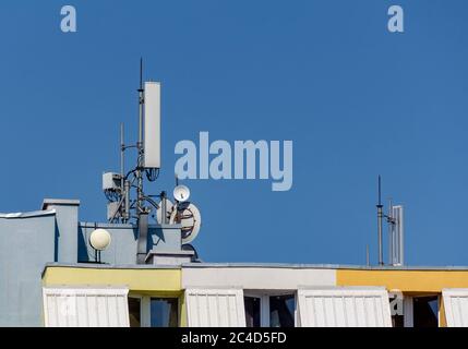 Cellular phone connection antennas on a residential building, 5G threat Stock Photo