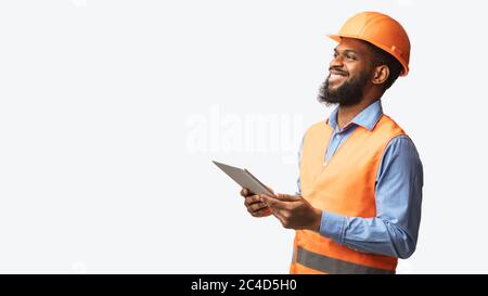 African Construction Foreman Worker Holding Tablet Computer Over White Background Stock Photo