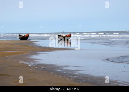 lonely twin boats at mandermoni sea beach west bengal india Stock Photo