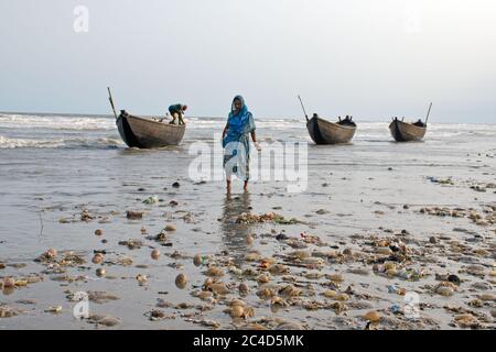 mandermoni sea beach west bengal india on may 29th 2018 : fisherwomen walking down on sea bech at mandermoni west bengal india. Stock Photo