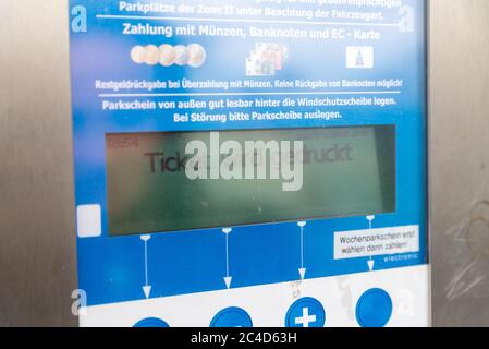 FEHMARN, GERMANY - Sep 05, 2019: A display of a parking ticket machine showing that the ticket is being printed. On the display you can also see a par Stock Photo