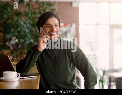 Wealthy young entrepreneur having conversation on smartphone Stock Photo