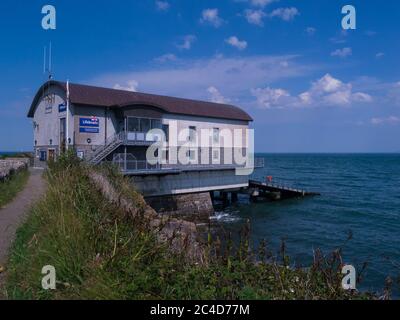 Busy new RNLI lifeboat station on Isle of Anglesey Coastal Path Moelfre North Wales UK high reputation for saving lives at sea Stock Photo