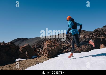 Trail running man runner in white winter mountains on snow. Stock Photo