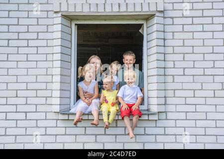 A Large Family is Lined Up and with a Dog Poses in Front of the Camera.  Stock Photo - Image of male, green: 164606456