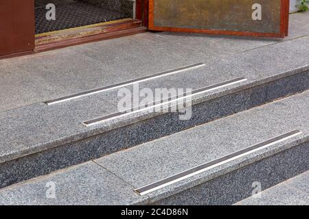 threshold of an old wooden front door with foot mat and rubber non-slip pads close up. Stock Photo