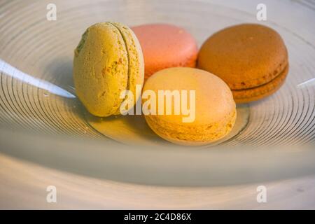 Closeup of colorful macarons in a glass bowl Stock Photo