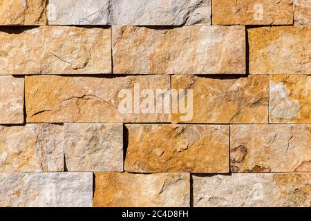 beige colour stone wall from tiles natural granite texture. Stock Photo