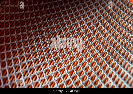 iron mesh frame of paper car air filter, closeup of spare parts with square pattern. background on a car theme. Stock Photo