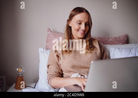 Young female entrepreneur working from home due to covid-19 lockdown situation Stock Photo