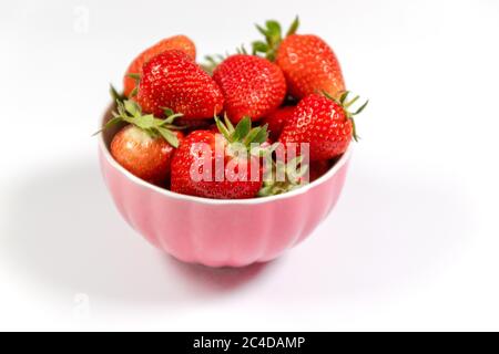 Bowl with fresh strawberries on white background. Summer composition Stock Photo