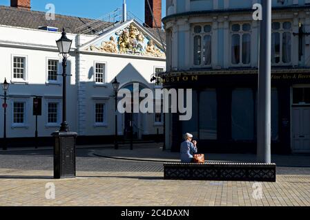 Woman drinking coffee in Trinity Square, Hull, Humberside, East Yorkshire, England UK Stock Photo