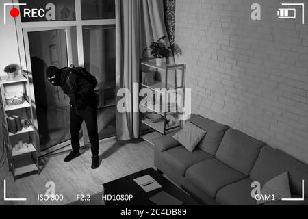 Thief With Crowbar Entering Into House View From Camera Stock Photo