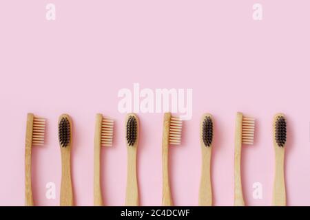Top view of organic zero waste bamboo toothbrushes on pink background Stock Photo