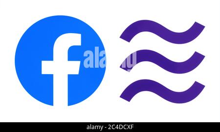 Kiev, Ukraine - October 29, 2019: New Facebook logo with Libra logo printed on paper. Libra is a proposed permissioned blockchain virtual currency by Stock Photo