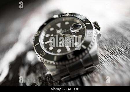 Close-up, shallow focus view of a well-known, Swiss manufactured mechanical diving watch showing detail of the its face and rotating ceramic bezel. Stock Photo