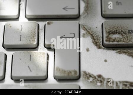 Close-up of a very dirty desktop keyboard from a well-known, computer and smartphone vendor.Showing grime on various keys. Stock Photo