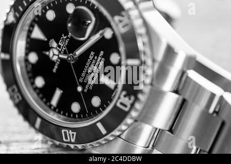 Close-up, shallow focus of a model designation of an iconic, luxury Swiss Made men's wrist watch.Also showing the ceramic bezel and cyclops date lens. Stock Photo