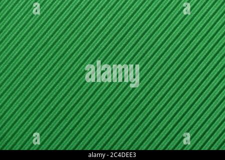 Light green colored corrugated cardboard texture useful as a background Textured corrugated striped cardboard green Stock Photo