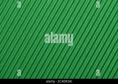 Light green colored corrugated cardboard texture useful as a background Textured corrugated striped cardboard green Stock Photo