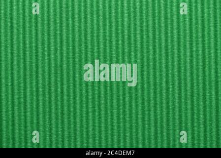 Light green colored corrugated cardboard texture useful as a background Textured corrugated striped cardboard green Stock Photo