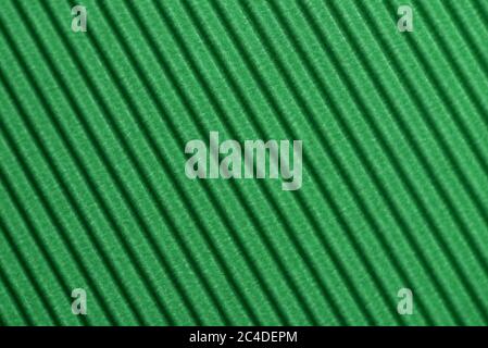 Light green colored corrugated cardboard texture useful as a background Textured corrugated striped cardboard green Stock Photo