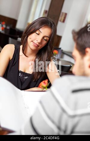 Young couple in the restaurant looks at the menu