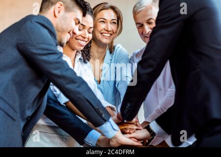 United Colleagues Holding Hands Standing In Circle During Teambuilding Event Stock Photo