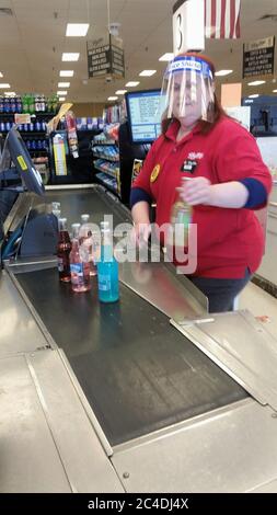 ELLENVILLE, NY, UNITED STATES - May 07, 2020: Ellenville, NY / USA - 05/07/2020: Shoprite Grocery Store Employee Cashier Rings Up Merchandise Wearing Stock Photo