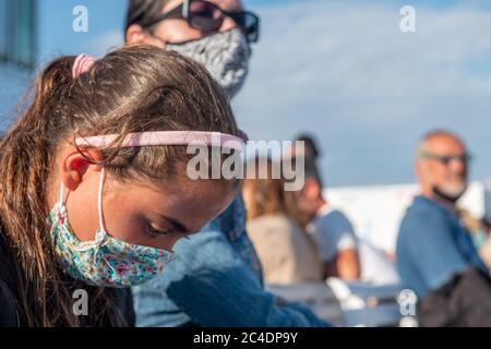 Group of tourists wearing masks on the ferry boat. Covid 19 travel concept Stock Photo