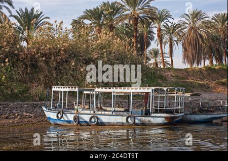 Traditional egyptian felluca sailing boat moored on bank of river Nile Stock Photo
