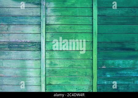 green grungy wooden board panels background, decorative weathered house wall Stock Photo