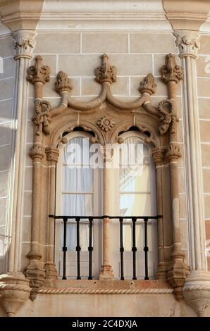 Beautiful Arabesque - Gothic Manueline marble window and surround on a stone facade. Evora, Alentejo region, Portugal. UNESCO World Heritage site. Stock Photo