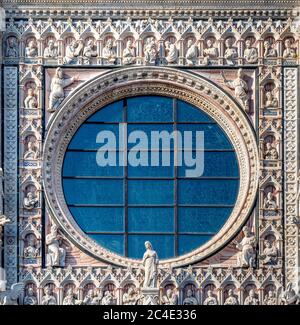 Circular window in the front facade of Siena Cathedral. Siena, Italy. Stock Photo
