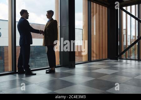 Business people meeting each other at office building and shaking hands Stock Photo