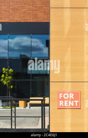 Image of placard For Rent on the wall of modern house Stock Photo