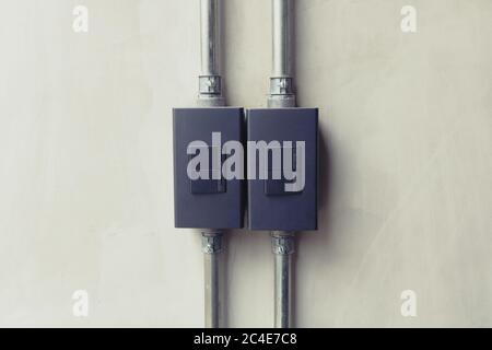 Close up of black lighting switch button on concrete wallpaper background with copy space. Stock Photo