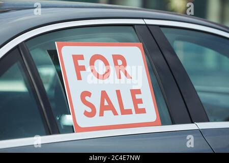 Close-up of placard For Sale on the window of car Stock Photo