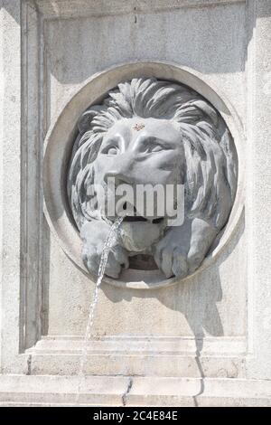 A bas relief style Lion's head embedded in pillar with ornate caps at ...